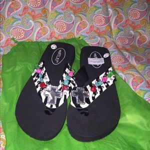 Woman’s size 7 rhinestone flip flops